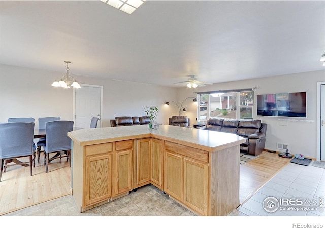 10538 Quivas St, Northglenn, CO 80234 - kitchen with open floor plan, light countertops, a chandelier, a ceiling fan, and pendant lighting
