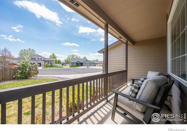 balcony featuring covered porch and a residential view