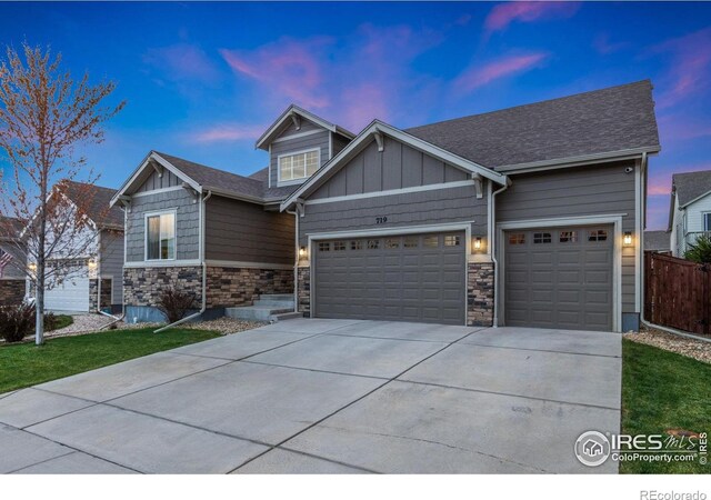 719 Wagon Bend Rd, Berthoud, CO 80513 - craftsman house with fence, stone siding, board and batten siding, an attached garage, and driveway