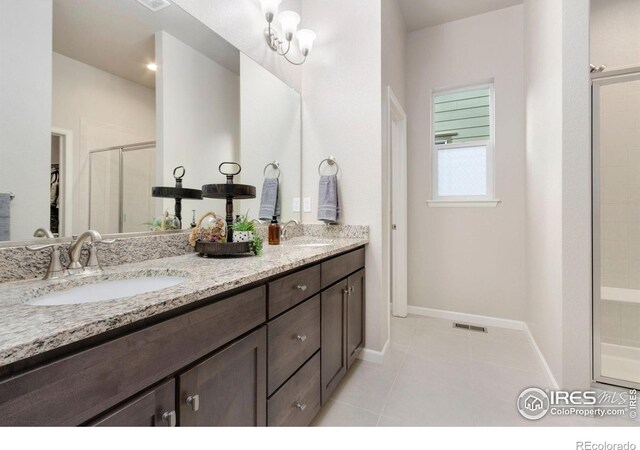 719 Wagon Bend Rd, Berthoud, CO 80513 - bathroom with a sink, baseboards, a stall shower, and double vanity