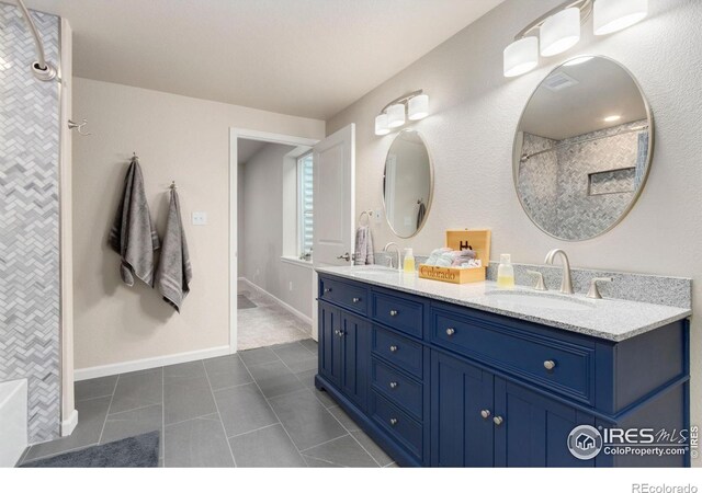 719 Wagon Bend Rd, Berthoud, CO 80513 - bathroom featuring double vanity, a sink, tile patterned floors, and a shower