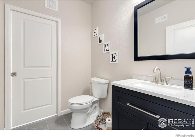 719 Wagon Bend Rd, Berthoud, CO 80513 - half bathroom with vanity, tile patterned flooring, toilet, and visible vents