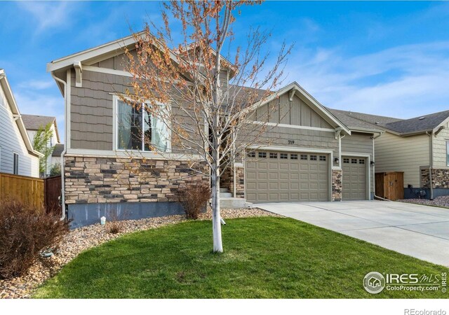 719 Wagon Bend Rd, Berthoud, CO 80513 - craftsman-style home featuring an attached garage, concrete driveway, a front yard, and stone siding