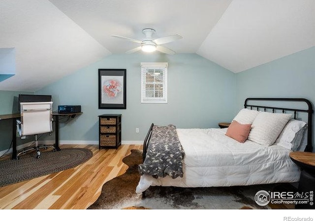 bedroom with baseboards, lofted ceiling, wood finished floors, and ceiling fan