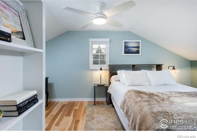bedroom with a ceiling fan, baseboards, wood finished floors, and lofted ceiling