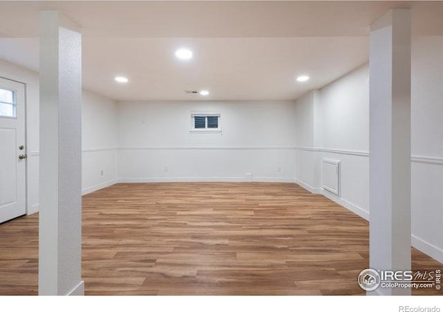 below grade area featuring recessed lighting, light wood finished floors, and baseboards