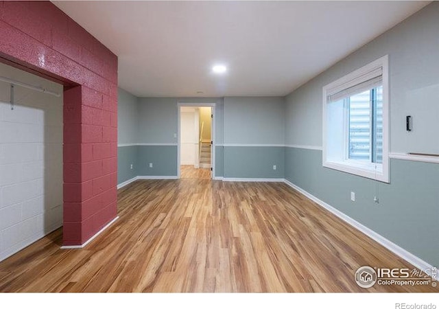 unfurnished bedroom featuring baseboards and light wood-style flooring