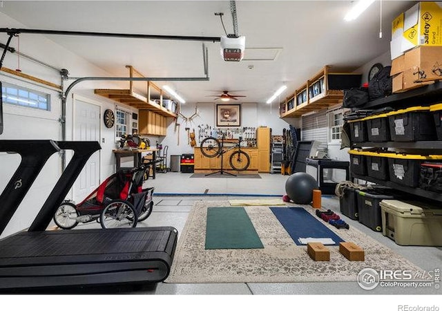 workout area with ceiling fan and a garage