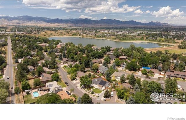 drone / aerial view featuring a water and mountain view