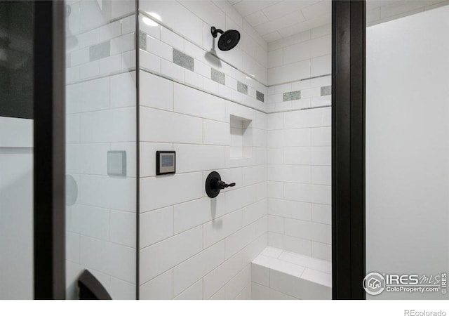 full bath featuring tiled shower