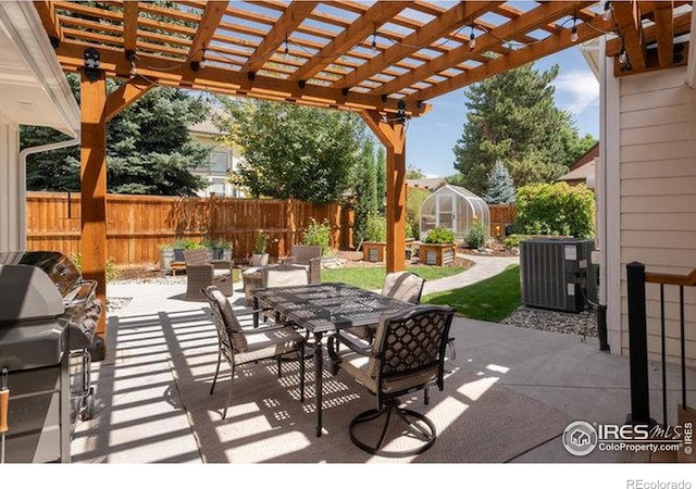 view of patio / terrace featuring a fenced backyard, outdoor dining space, a greenhouse, and central AC