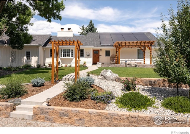 14117 W 58th Pl, Arvada, CO 80004 - view of front of home with a pergola, solar panels, board and batten siding, and a front lawn