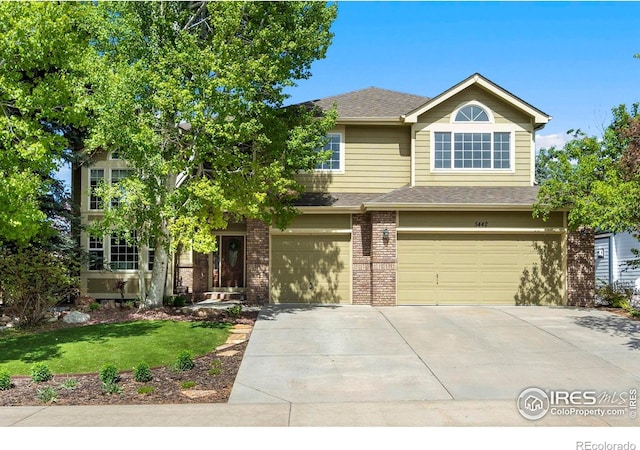 5442 Tiller Ct, Windsor, CO 80528 - view of front facade with driveway, roof with shingles, brick siding, a front lawn, and an attached garage