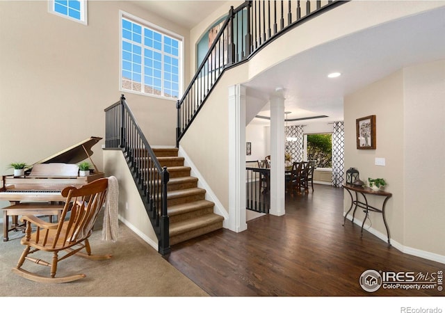 5442 Tiller Ct, Windsor, CO 80528 - staircase featuring baseboards, decorative columns, and wood finished floors