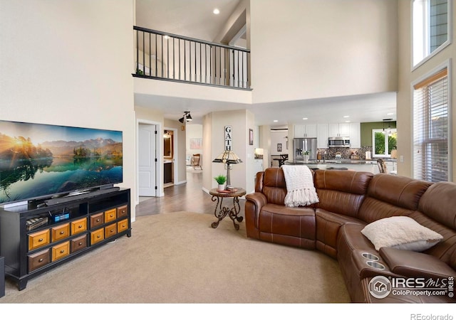 5442 Tiller Ct, Windsor, CO 80528 - living room with recessed lighting, a towering ceiling, and light carpet