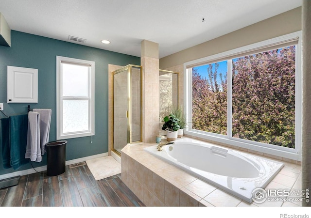 5442 Tiller Ct, Windsor, CO 80528 - full bath with baseboards, visible vents, a bath, and a stall shower