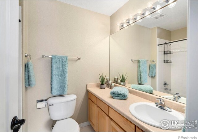5442 Tiller Ct, Windsor, CO 80528 - bathroom featuring vanity, walk in shower, toilet, and visible vents