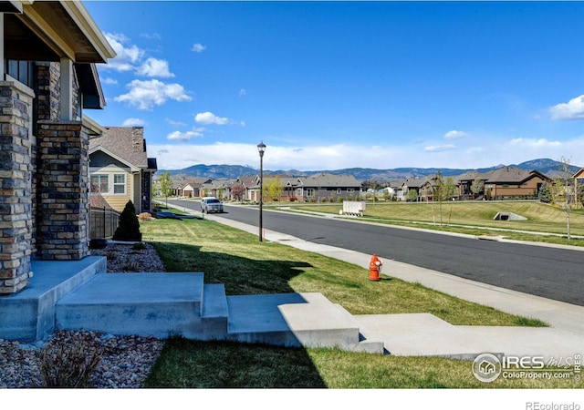 3558 Prickly Pear Dr, Loveland, CO 80537 - view of street with street lighting, a mountain view, a residential view, and sidewalks