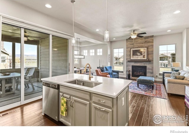 3558 Prickly Pear Dr, Loveland, CO 80537 - kitchen with stainless steel dishwasher, ceiling fan, visible vents, and a sink