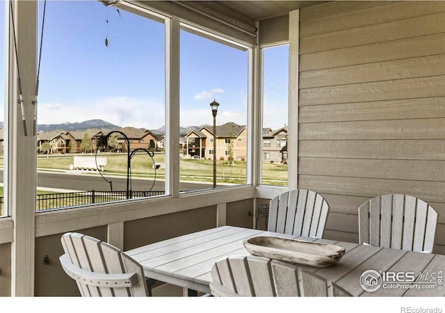 3558 Prickly Pear Dr, Loveland, CO 80537 - sunroom featuring a mountain view, a residential view, and outdoor dining area