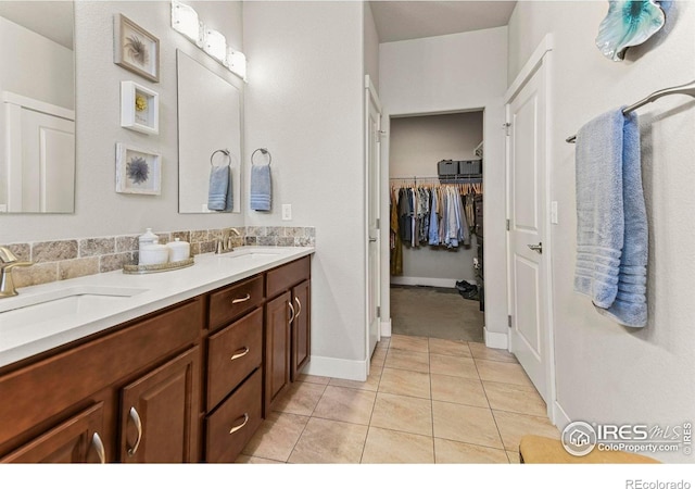 3558 Prickly Pear Dr, Loveland, CO 80537 - bathroom with a sink, tile patterned floors, double vanity, and a walk in closet