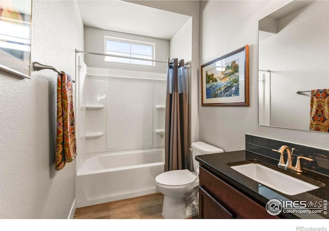 3558 Prickly Pear Dr, Loveland, CO 80537 - full bath featuring wood finished floors, vanity, toilet, a textured wall, and shower / bathtub combination with curtain