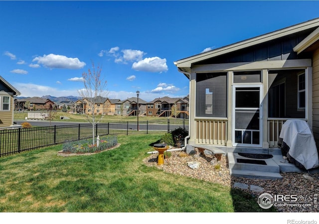 3558 Prickly Pear Dr, Loveland, CO 80537 - view of yard with a residential view, a fenced backyard, and a sunroom