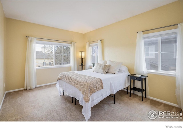 bedroom featuring carpet flooring and baseboards