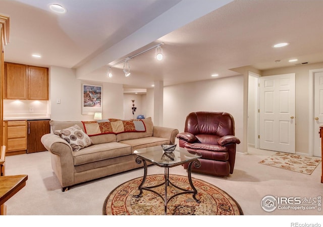 living area with rail lighting, visible vents, recessed lighting, and light colored carpet