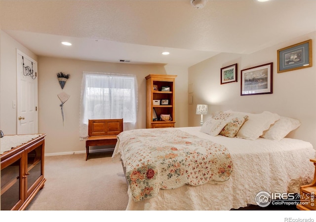 bedroom with recessed lighting, baseboards, light colored carpet, and visible vents