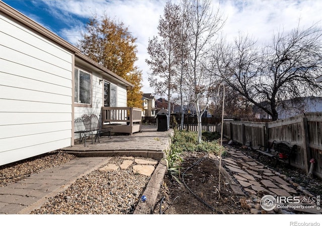 view of yard with a deck and a fenced backyard