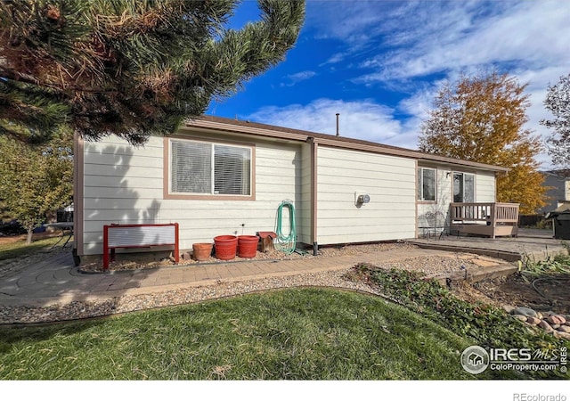 back of property featuring a wooden deck