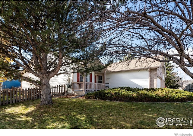 obstructed view of property featuring fence private yard, a garage, and a front lawn