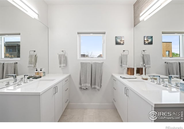 2907 32nd St, Boulder, CO 80301 - full bathroom featuring tile patterned floors, baseboards, and two vanities