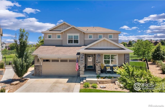 1977 Shadow Lake Ct, Windsor, CO 80550 - craftsman inspired home with covered porch, a garage, driveway, board and batten siding, and stone siding