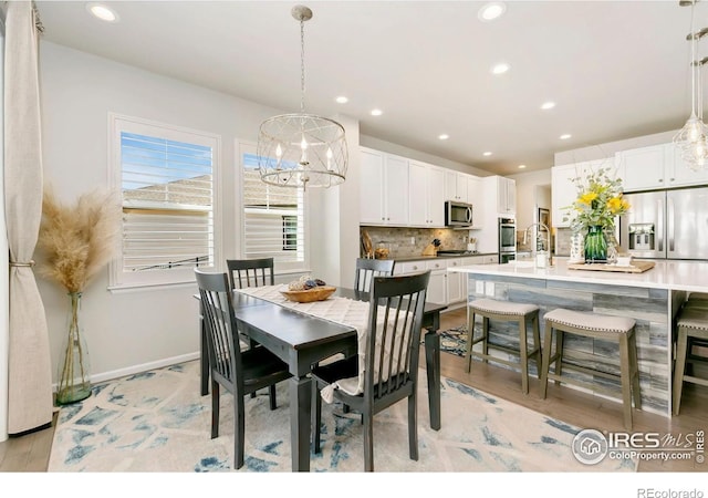 1977 Shadow Lake Ct, Windsor, CO 80550 - dining space featuring a chandelier, recessed lighting, baseboards, and light wood-style flooring