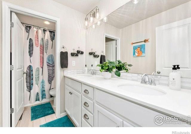 1977 Shadow Lake Ct, Windsor, CO 80550 - bathroom featuring double vanity, tile patterned flooring, toilet, and curtained shower