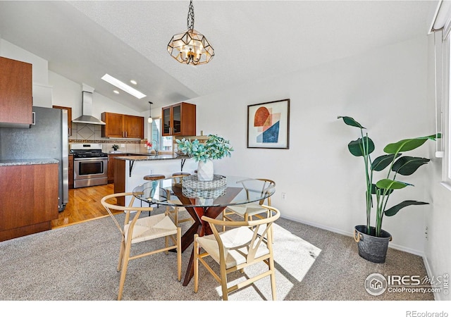 3812 Howe Ct, Boulder, CO 80301 - dining area with vaulted ceiling, a chandelier, light carpet, and baseboards