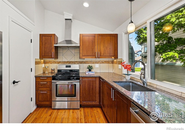 3812 Howe Ct, Boulder, CO 80301 - kitchen featuring stainless steel appliances, wall chimney exhaust hood, vaulted ceiling, a sink, and light wood-type flooring
