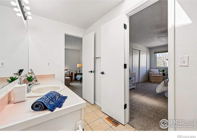 3812 Howe Ct, Boulder, CO 80301 - bathroom featuring tile patterned flooring, vanity, and a textured ceiling