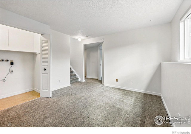 3812 Howe Ct, Boulder, CO 80301 - below grade area with carpet floors, stairs, baseboards, and a textured ceiling
