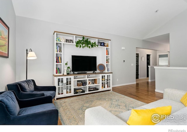 1689 Maseca Plaza Way, Severance, CO 80550 - living area with baseboards, wood finished floors, and lofted ceiling