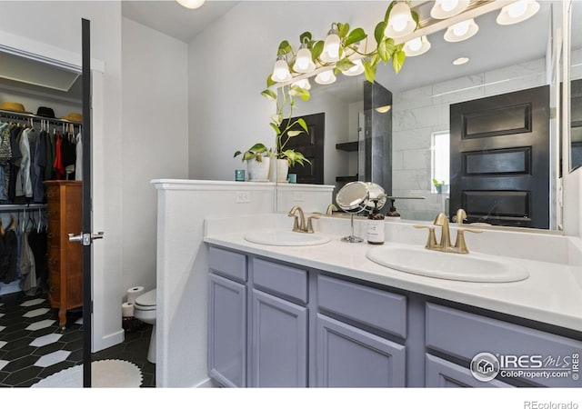 1689 Maseca Plaza Way, Severance, CO 80550 - full bathroom with double vanity, toilet, a spacious closet, and a sink