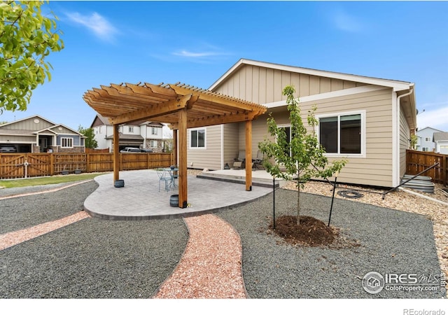 1689 Maseca Plaza Way, Severance, CO 80550 - view of front facade with a patio, a fenced backyard, board and batten siding, and a pergola