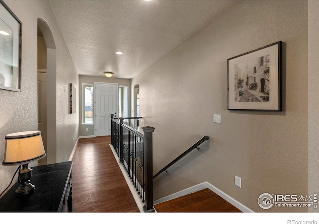 850 Prairiestar Dr, Berthoud, CO 80513 - interior space with baseboards, a textured wall, arched walkways, and wood finished floors