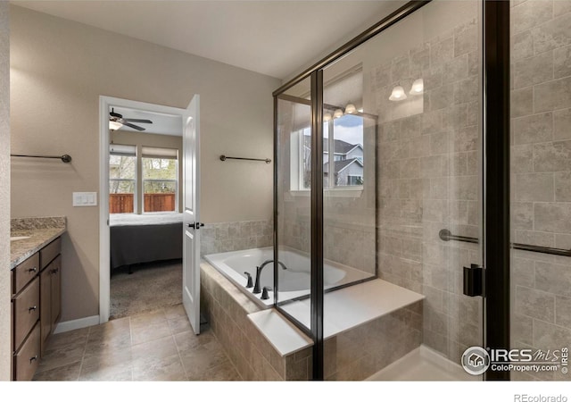 850 Prairiestar Dr, Berthoud, CO 80513 - ensuite bathroom with a ceiling fan, tile patterned flooring, a shower stall, ensuite bathroom, and tiled bath