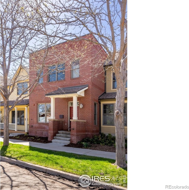 view of front of home with brick siding