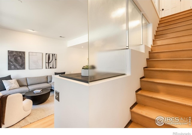 interior space with stairs and wood finished floors