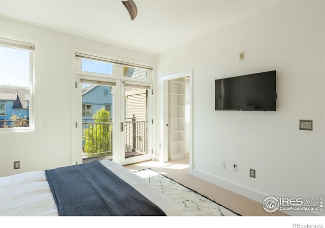 bedroom featuring access to outside, ceiling fan, ensuite bath, carpet floors, and baseboards