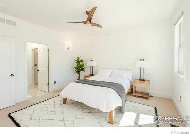 bedroom with baseboards, ceiling fan, and visible vents